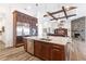 Open kitchen with a large island, stainless steel appliances, and a view into the adjacent living area with a stone fireplace at 35651 Huff Rd, Eustis, FL 32736