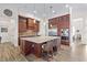 Modern kitchen featuring rich wooden cabinets, a large island with counter seating and professional grade stainless steel appliances at 35651 Huff Rd, Eustis, FL 32736