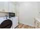 Well-equipped laundry room with front loading washer and dryer, built-in cabinets, and ample counter space at 35651 Huff Rd, Eustis, FL 32736