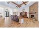 Open living room featuring wood-look tile, a fireplace and exposed wood beams at 35651 Huff Rd, Eustis, FL 32736