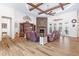 Spacious living room featuring a stone fireplace and wood-look tile floors at 35651 Huff Rd, Eustis, FL 32736