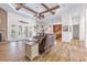 Spacious living room featuring a stone fireplace and an open layout to the kitchen at 35651 Huff Rd, Eustis, FL 32736