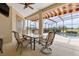 Cozy outdoor patio with comfortable seating, and a view of the pool and backyard at 35651 Huff Rd, Eustis, FL 32736