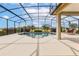Resort-style screened-in pool with expansive patio, lush landscaping, and comfortable lounge seating at 35651 Huff Rd, Eustis, FL 32736
