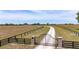 Gated property with long driveway and large open fields at 35651 Huff Rd, Eustis, FL 32736