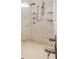 Walk-in shower with multiple shower heads and marbled walls at 35651 Huff Rd, Eustis, FL 32736