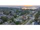 Gorgeous aerial view of a neighborhood, showcasing mature trees and waterfront access at sunset at 4265 Conway Place Cir, Orlando, FL 32812