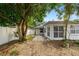 Backyard area with gravel, patio pavers, and various trees, shrubs, and plants at 4265 Conway Place Cir, Orlando, FL 32812