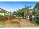 Backyard with a gravel area, wooden pergola, garden bed, and various trees and shrubbery at 4265 Conway Place Cir, Orlando, FL 32812