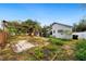 Backyard featuring garden beds, brick and wood pergola, with a house in the background at 4265 Conway Place Cir, Orlando, FL 32812