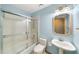 Bathroom featuring a combined tub and shower with a pedestal sink and blue walls at 4265 Conway Place Cir, Orlando, FL 32812