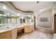 Bathroom featuring double sinks, granite countertops, glass block window, soaking tub, and walk-in shower at 4265 Conway Place Cir, Orlando, FL 32812