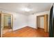 Bedroom with hardwood floors, open closet, and view to hallway with tiled floor at 4265 Conway Place Cir, Orlando, FL 32812