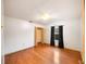 Bedroom with wood floors, white walls, window with black curtains, and an open closet at 4265 Conway Place Cir, Orlando, FL 32812