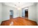 Bright dining room with hardwood floors, chandelier, and multiple entryways to adjacent rooms at 4265 Conway Place Cir, Orlando, FL 32812