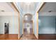 Foyer featuring tile floors, an arched doorway, and views into the living room and kitchen areas at 4265 Conway Place Cir, Orlando, FL 32812
