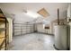 Spacious garage with storage shelves, water heater, and an automatic garage door at 4265 Conway Place Cir, Orlando, FL 32812