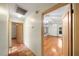 Hallway with tile flooring leading to the main living area featuring hardwood floors at 4265 Conway Place Cir, Orlando, FL 32812