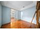 Home office with wood floors, and a view of the tiled hallway with an arched entryway at 4265 Conway Place Cir, Orlando, FL 32812