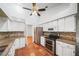 Kitchen featuring white cabinetry, stainless steel appliances, and tile backsplash at 4265 Conway Place Cir, Orlando, FL 32812