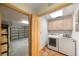 Laundry room with washer and dryer, storage cabinets, and a view into the garage at 4265 Conway Place Cir, Orlando, FL 32812
