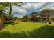Spacious backyard featuring an in-ground pool, green lawn, and privacy fencing for outdoor enjoyment at 502 Oak Ln, Maitland, FL 32751