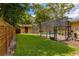 The home's backyard contains a pool, and pool house with private, wood fence surrounding yard at 502 Oak Ln, Maitland, FL 32751