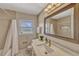 The remodeled bathroom features a shower/tub combo, white marble countertop, and stainless steel hardware at 502 Oak Ln, Maitland, FL 32751