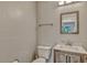 This powder room is complete with wood-look vanity, white countertop, and a view of the backyard at 502 Oak Ln, Maitland, FL 32751