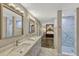 This long bathroom features double sinks, and a shower on each end, with a view of the bedroom at 502 Oak Ln, Maitland, FL 32751