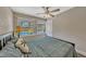 This bedroom has neutral walls, wood floors, a ceiling fan, and a great view of the backyard pool at 502 Oak Ln, Maitland, FL 32751