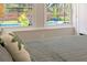 This bedroom has neutral walls, wood floors, and a great view of the backyard pool from the bed at 502 Oak Ln, Maitland, FL 32751
