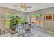 Bright dining room with a glass table, views of the landscaped backyard, and elegant marble flooring at 502 Oak Ln, Maitland, FL 32751