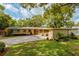 Welcoming single-Gathering home with a vibrant front lawn, mature trees, and double garage at 502 Oak Ln, Maitland, FL 32751