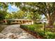 Charming single-story home with a well-maintained lawn and mature trees along an extended driveway at 502 Oak Ln, Maitland, FL 32751