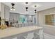 Stylish kitchen with gray cabinets, quartz countertops, an island with bar seating, and stainless steel appliances at 502 Oak Ln, Maitland, FL 32751