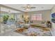 Bright living room with marble floors, neutral furniture, and a seamless transition to the dining area at 502 Oak Ln, Maitland, FL 32751