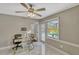Well-lit home office with modern desk, marble floors, and a view of the pool area at 502 Oak Ln, Maitland, FL 32751