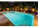 Backyard pool at night features bright pool lights and landscape lighting for an inviting outdoor space at 502 Oak Ln, Maitland, FL 32751