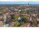 Aerial view of the neighborhood featuring red tile roofs, mature landscaping, and a luxurious community pool at 546 Via Fontana Dr # 203, Altamonte Springs, FL 32714