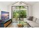 Bright sitting room area with vaulted ceiling and a private balcony with treetop views at 546 Via Fontana Dr # 203, Altamonte Springs, FL 32714