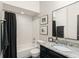 Modern bathroom boasts a granite countertop, stylish fixtures, and a bathtub with a shower at 546 Via Fontana Dr # 203, Altamonte Springs, FL 32714