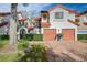 Charming multi-story townhome features a private two-car garage, lush landscaping, and a beautiful red tile roof at 546 Via Fontana Dr # 203, Altamonte Springs, FL 32714