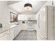 Cozy bright kitchen featuring white cabinets, stylish flooring and modern appliances at 546 Via Fontana Dr # 203, Altamonte Springs, FL 32714