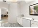 Bright kitchen features a black and white patterned floor and a window overlooking the yard at 546 Via Fontana Dr # 203, Altamonte Springs, FL 32714