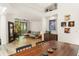 Bright living room view from dining featuring a vaulted ceiling, comfortable seating and balcony access at 546 Via Fontana Dr # 203, Altamonte Springs, FL 32714
