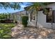 Lovely home's backyard with beautiful landscaping, brick walkway, and screened-in pool at 5909 Oxford Moor Blvd, Windermere, FL 34786