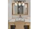 Elegant bathroom vanity area featuring a gold-framed mirror and a set of perfume bottles on a tray at 5909 Oxford Moor Blvd, Windermere, FL 34786