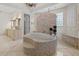 Elegant bathroom featuring a mosaic-tiled tub, complemented by a chandelier and dual vanity setup at 5909 Oxford Moor Blvd, Windermere, FL 34786