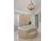Opulent bathroom with an elegant tiled bathtub, accented by natural light and an open doorway at 5909 Oxford Moor Blvd, Windermere, FL 34786